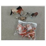 Flat of toy horses and two old Santa Claus dolls