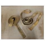 Two tie down straps, 2 in wide, one has a hook