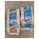 2 bags of mortar, one is white, one is gray,