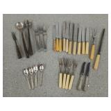 Collection of cutlery, most are stainless steel,