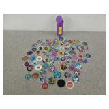 Collection of pogs, some have Felix the cat,