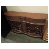 Beautiful wooden entry piece with metal doors a