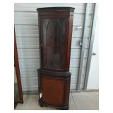 Wooden corner cabinet with two glass shelves and