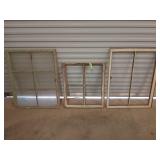 Three old window frames, only one has glass,