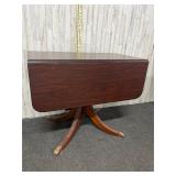 Wooden drop-leaf pedestal dining table