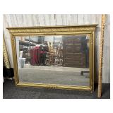 Gold colored framed mirror
