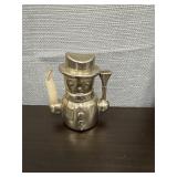 Silver colored metal snowman candle holder