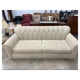 Beige Upholstered Sofa with Tufted Backrest