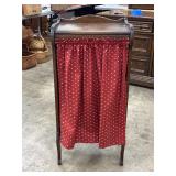Wooden Cabinet With Shelves and Red Curtain