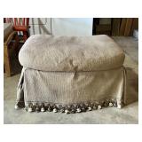 Upholstered Ottoman With Tassel Trim