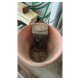 Large clay pot with a vintage metal mailbox, both