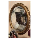 Overwhelm, gold plastic framed mirror with a