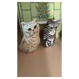 2 black-and-white porcelain cats, with openings