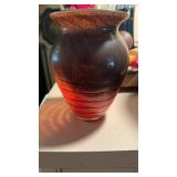 Orange speckled art glass base with a black,