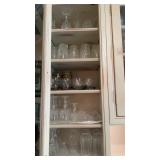 1 kitchen cabinet filled a drinking glasses,