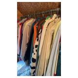 Collection of vintage clothing on hangers, in