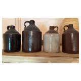 Four 4 brown stoneware jugs, three or 1 gallon,