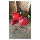 Two red gas cans filled with gas, with special