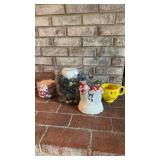 Two glass candleholders, a family, snowman,