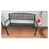Black aluminum bench, room for three, along with
