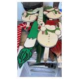 Group of holiday hand-painted yard ornaments,
