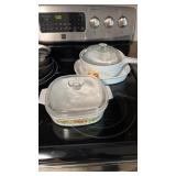 Three pieces of corning ware, a large cookpot,