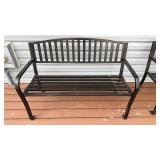 Black aluminum bench, on the back porch, room for