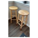 2 matching light wood barstools, that measure 29