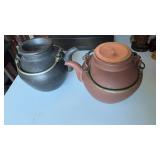 Two vintage clay teapot, one black clay with the
