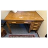 Small antique, four drawer, oak desk, with a pull