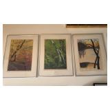 Three framed black prints by the same artist,