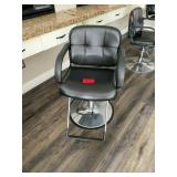 Black salon chair with metal base