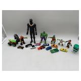 Collection of action figures and toy vehicles