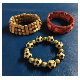 (3) Costume bracelets, (2) wooden & (1) red