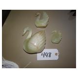 Three onyx swan figures