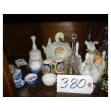 Shelf of assorted bells, shakers, mini tea pot, se