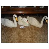 Three large ceramic swan figures