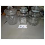 Three large glass counter canisters
