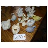 Assorted ceramic swan figurines and planters