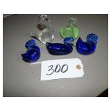 Three cobalt, one green and clear solid glass swan
