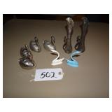 Assorted metal swan vases, candle holders, and fig