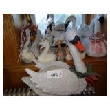 Shelf of assorted large fabric/stuffed swans