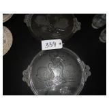 Two heavy round glass swan serving plates