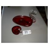 Two red art glass swan dishes, large and small