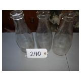 Three generic quart store milk bottles