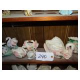 Shelf full of ceramic swan planters, one is Norcre