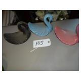 Three ceramic swan dishes, pink, blue, black