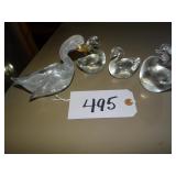 Four solid glass swan figures