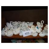 Shelf of small ceramic swan planters
