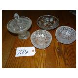 Three footed glass dishes, one is covered